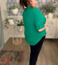 Person wearing a green shirt in a room with decor elements.